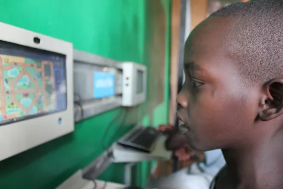 A boy explores the digital drum in Centre Meo, Bujumbura.