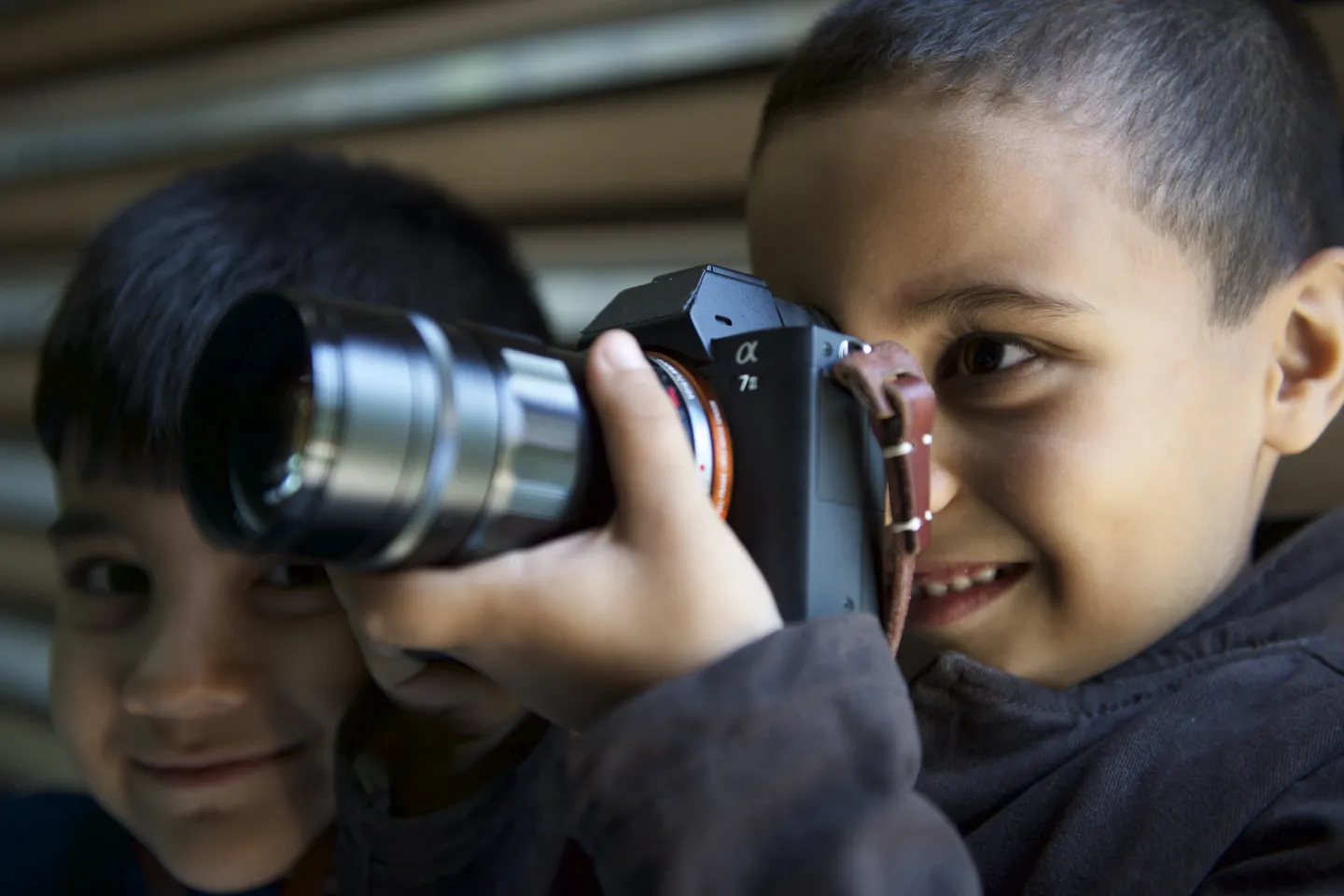 a child holding a camera 