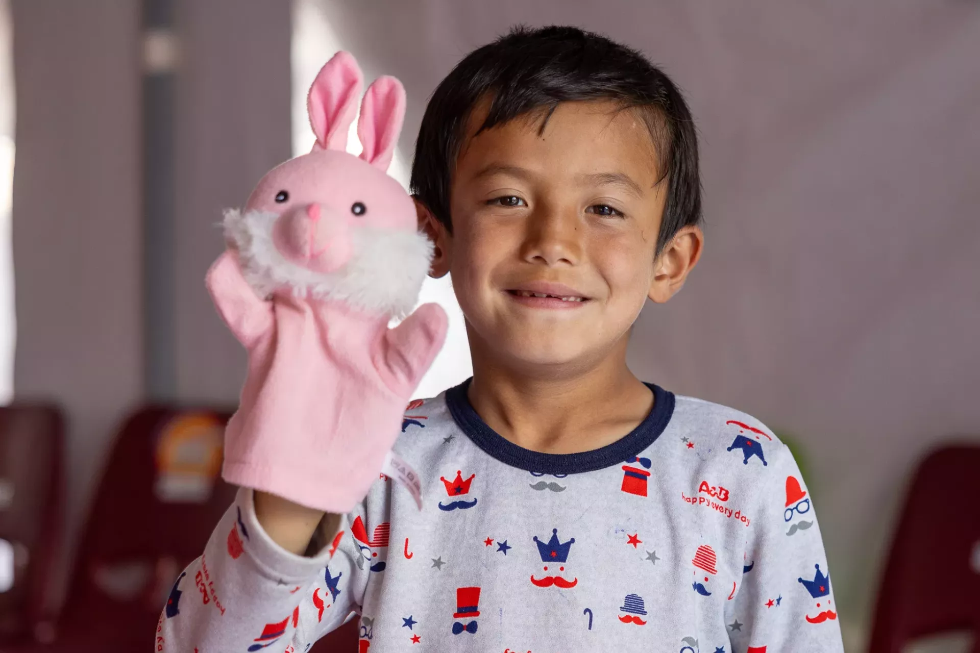 A refugee little boy playing with his toy.