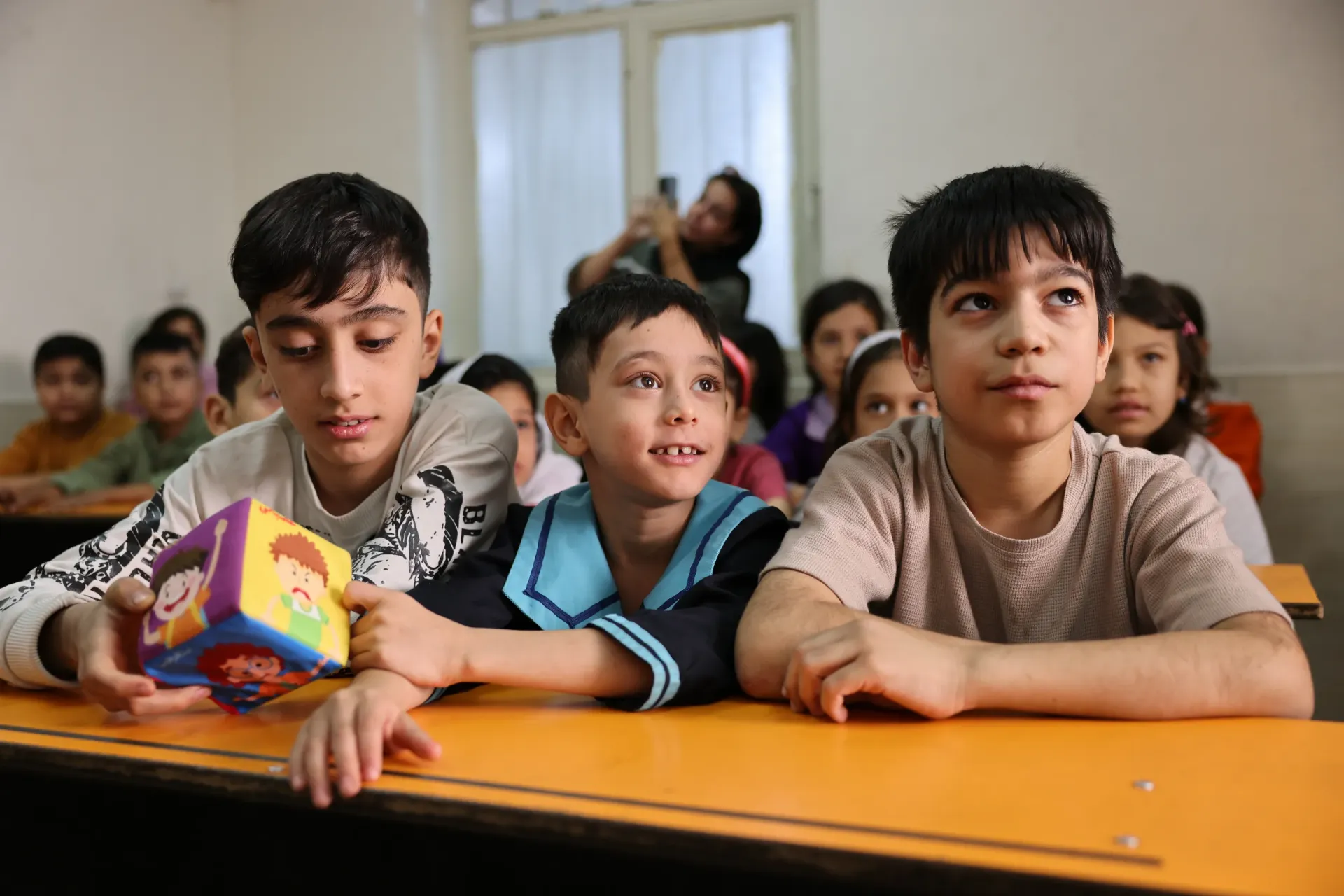 Children at Mehrabani School engaged and attentive as the counselor shares guidance and support.