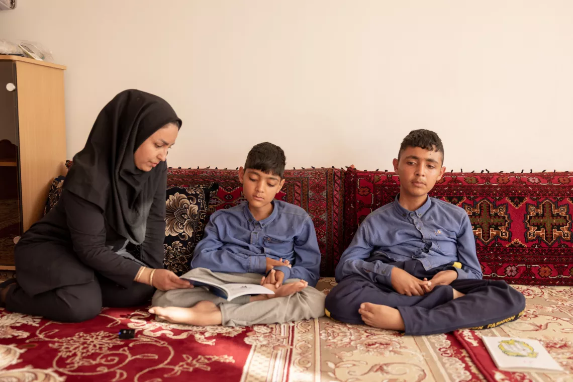 Anolfazl, Mohammad and their remedial class teacher are working on their Farsi lessons, Torbate Jam, Khorasan Razavi, Iran. 