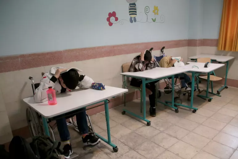 Children with disabilities in earthquake drill at school