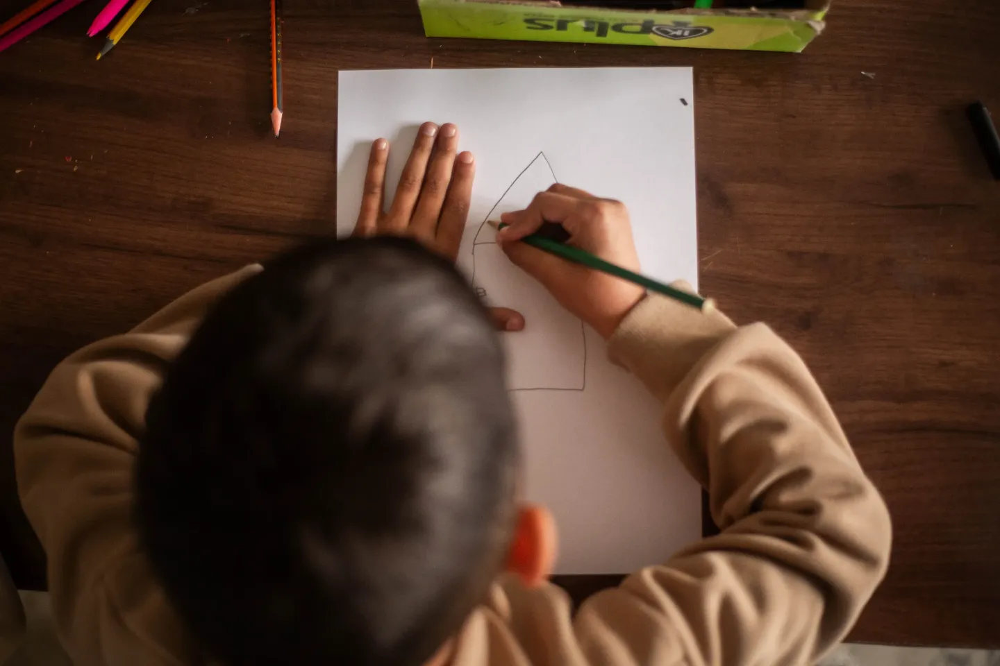 A child drawing home in a classroom in Falluja Rehabilitation Center