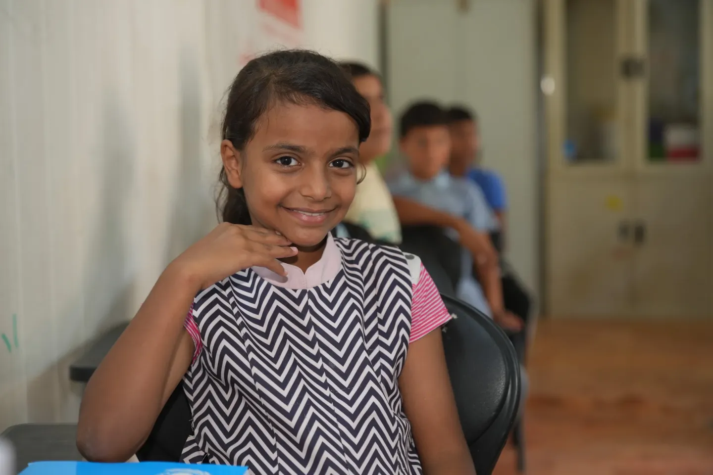 Young girl Jannat sitting and smiling in her class