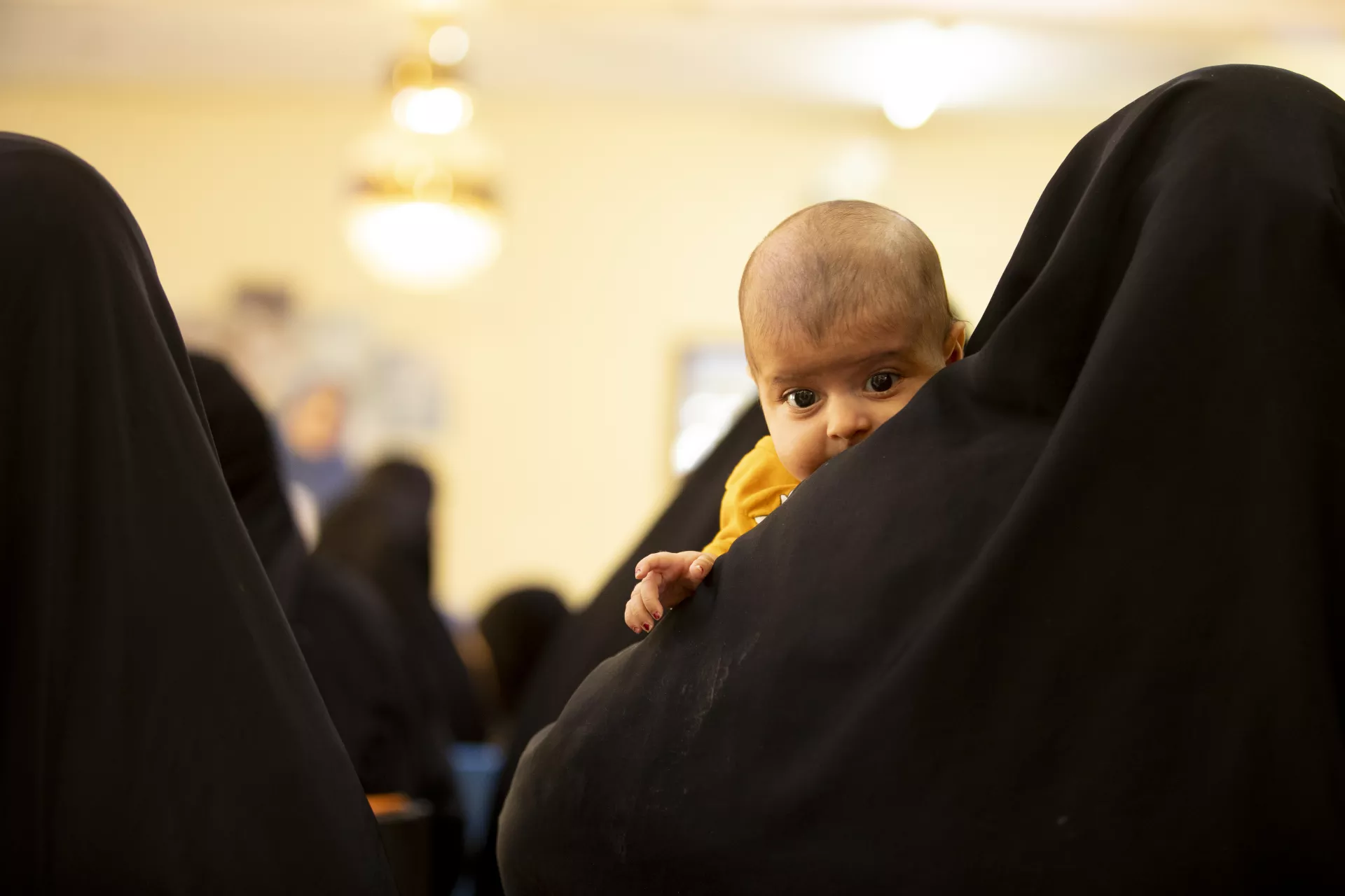Rawan Ali Abdullah, a 3-month-old baby girl with her mother Asma and her grandmother Furat, waiting to be vaccinated.  The family came to Al Shuaibi Primary Health Care Center to be vaccinated.