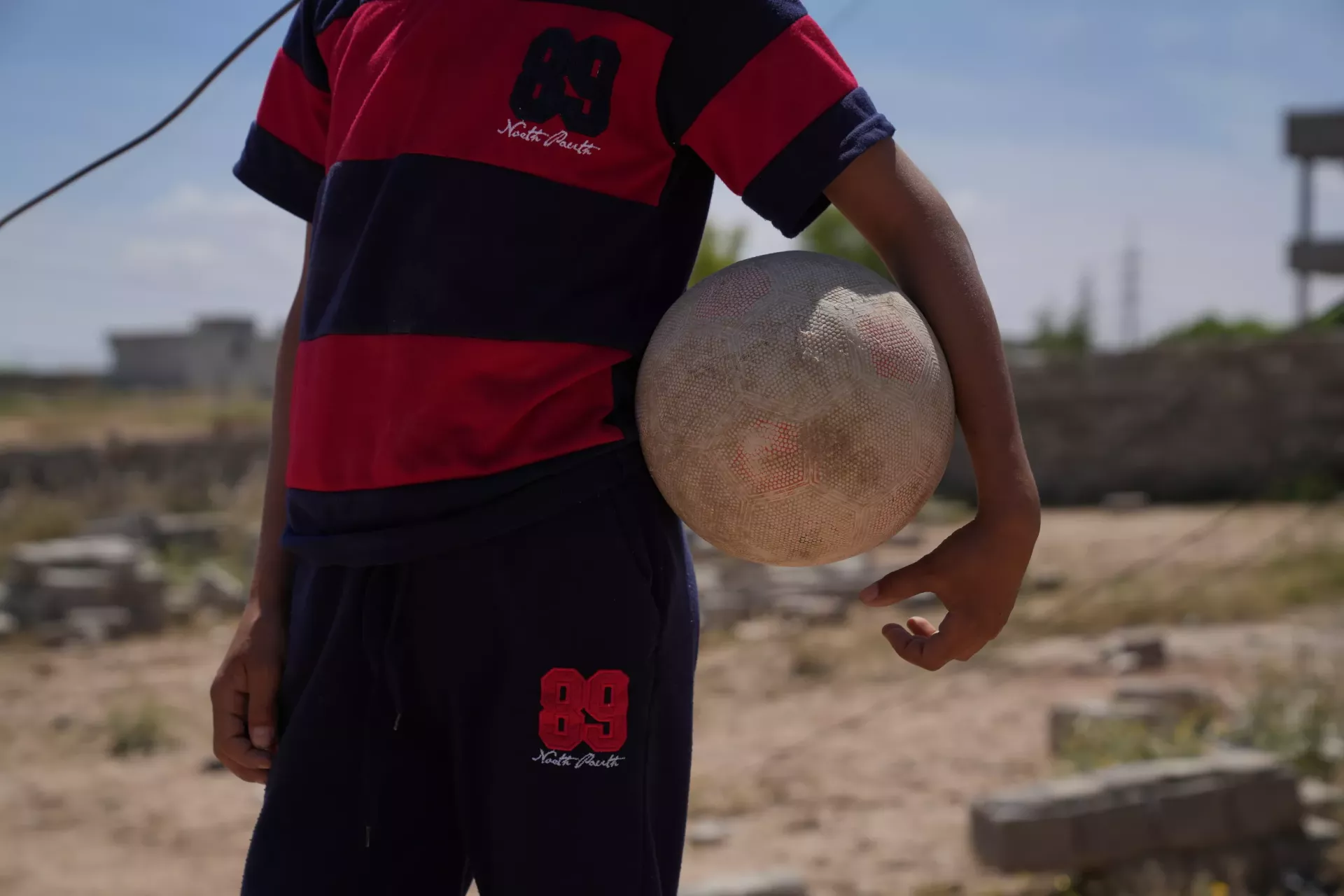 Yazan, playing football in Mosul city, Ninewa Governorate, Iraq.     