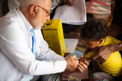 Medical Assistant in the Directorate of health, Daham Jassim is giving vaccine shot to 3yo boy, Hussein Mohammed during the boat mission to the Marshlands to visit the mobile clinics of the 2nd round of the multi-antigen campaign. 