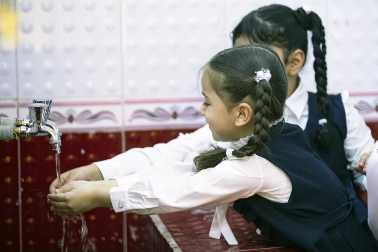 Two Student girls washing their hands in one of the schools in Basra 