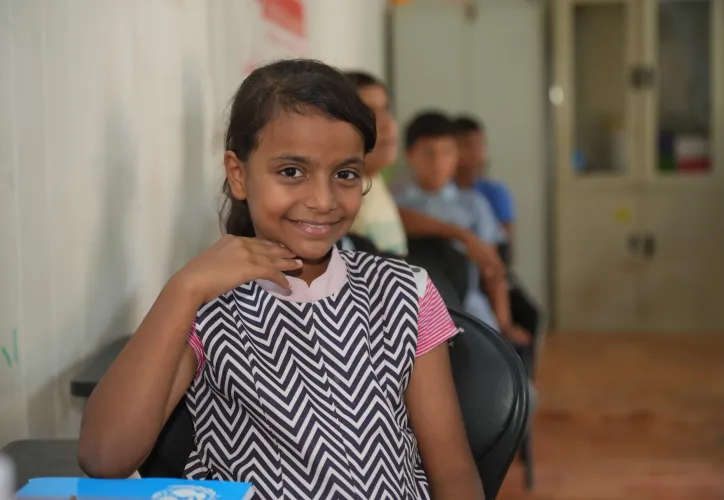Young girl Jannat sitting and smiling in her class