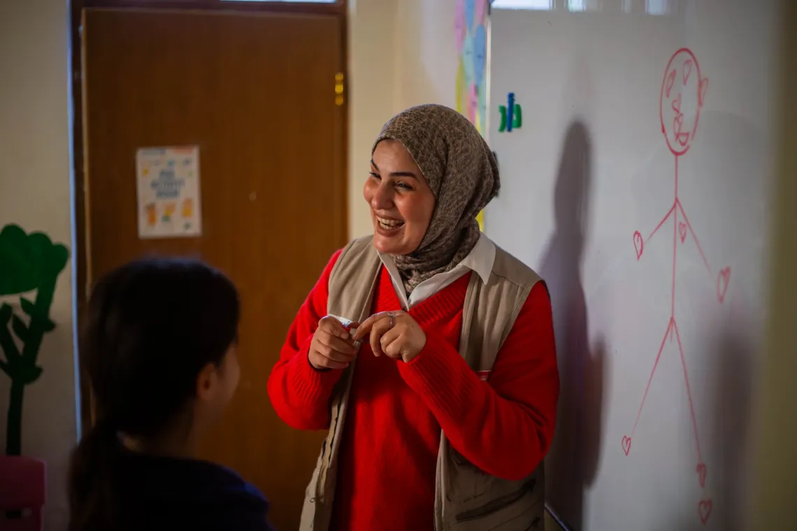 Asemaa supports children through psychosocial activities, drawing on her own experience to help them feel safe and understood.