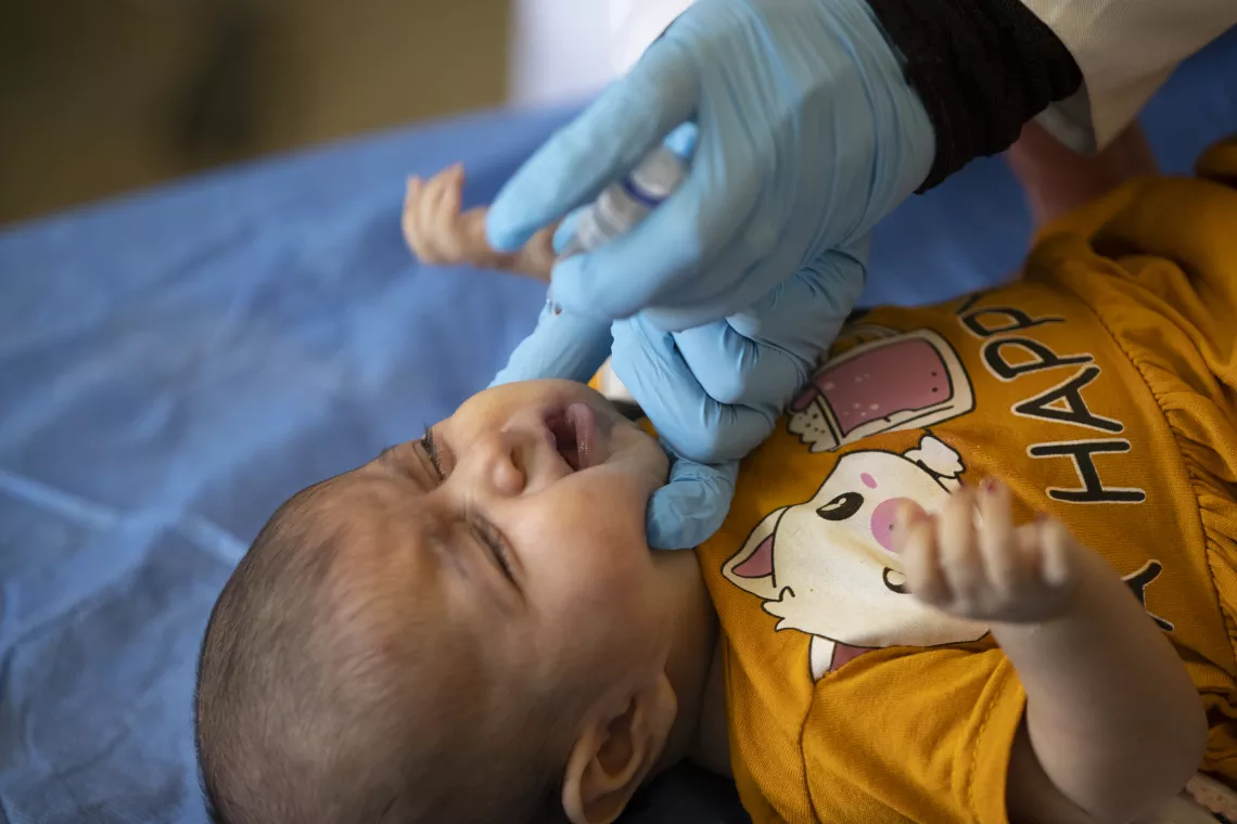 Rawan Ali Abdullah, a 3-month-old baby girl is getting vaccinated. With funding from Korea, UNICEF is supporting Al Shuaibi Primary Health Care Center by installing solar panels to ensure that vaccines storage temperatures are maintained during electricity cuts.