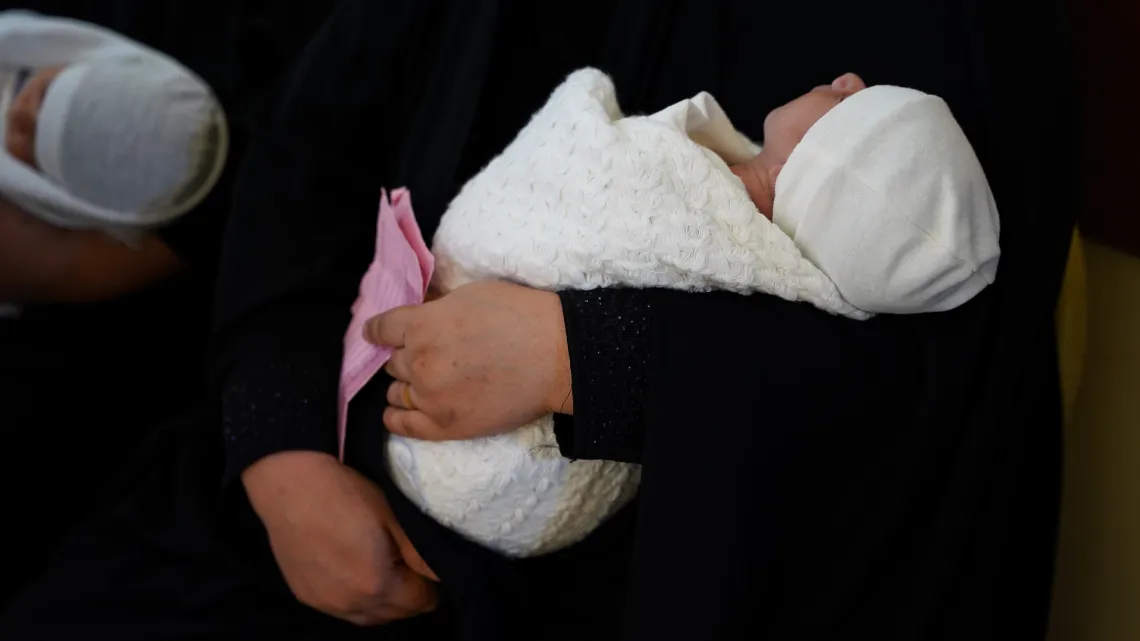 Sanad Ahmed- 13 days old (left) & Ameer Asaad- 12 days old babies are carried by their moms waiting to be vaccinated at Al Shuaibi Primary Health Care center