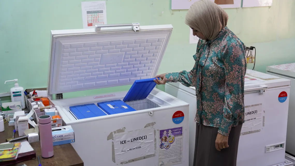 Hadeel Mohammed Ali Murad, Manager, Al Shuaibi Primary Health Care center is showing UNICEF the vaccine storage store and the refrigerators. 