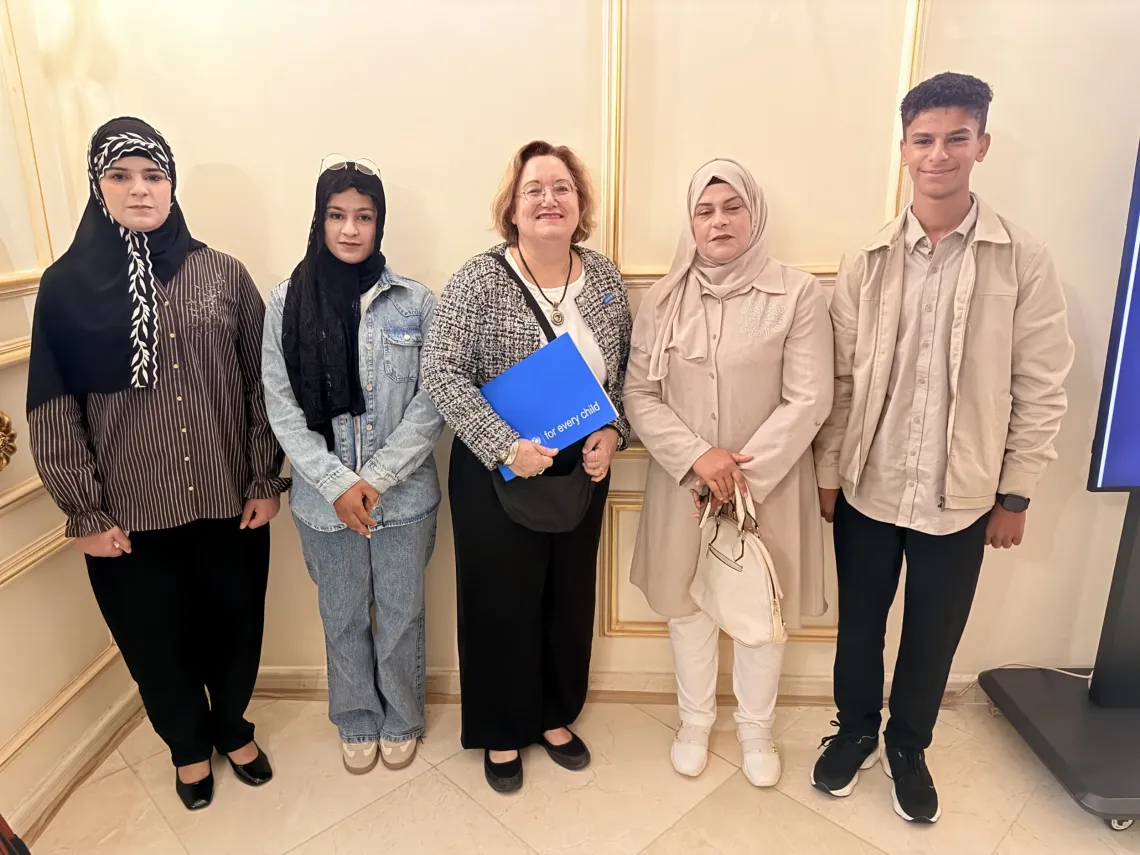 A shared moment of hope. UNICEF Deputy Representative for Programmes in Iraq, Laetitia Bazzi-Veil, stands with Suhaib&rsquo;s mother and sisters, as the family looks toward a brighter future through education.