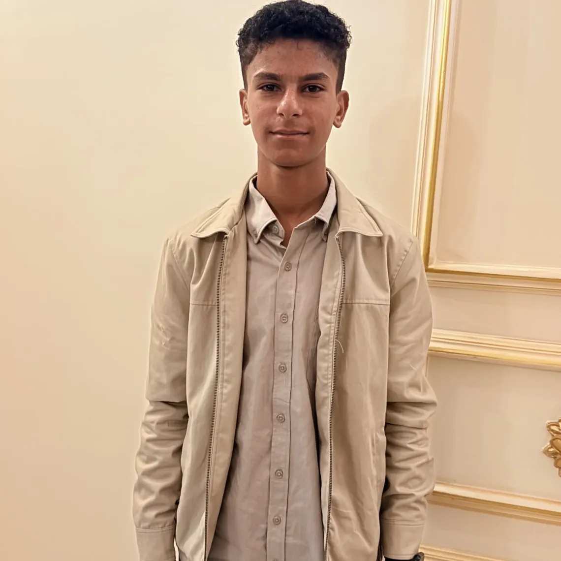 Back where he belongs, Suhaib, 13, smiles after sharing his return-to-school testimony at the national launch of the Back-to-Learning national event, ready to learn and pursue his dream of becoming a doctor