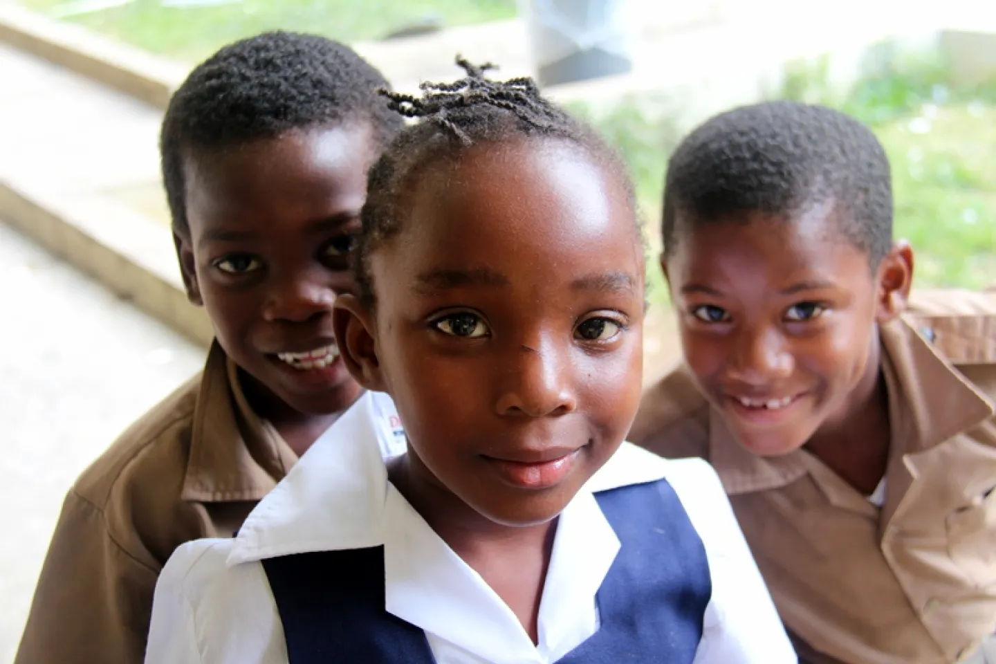Photograph of one schoolgirl and two schoolboys 