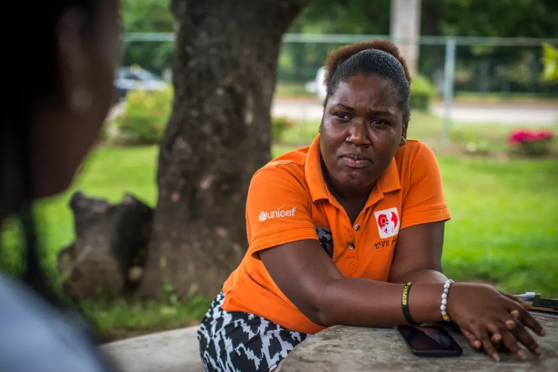 Photo of EVE for Life mentor mom Monique McDonald listening to a client in Ocho Rios, St Ann