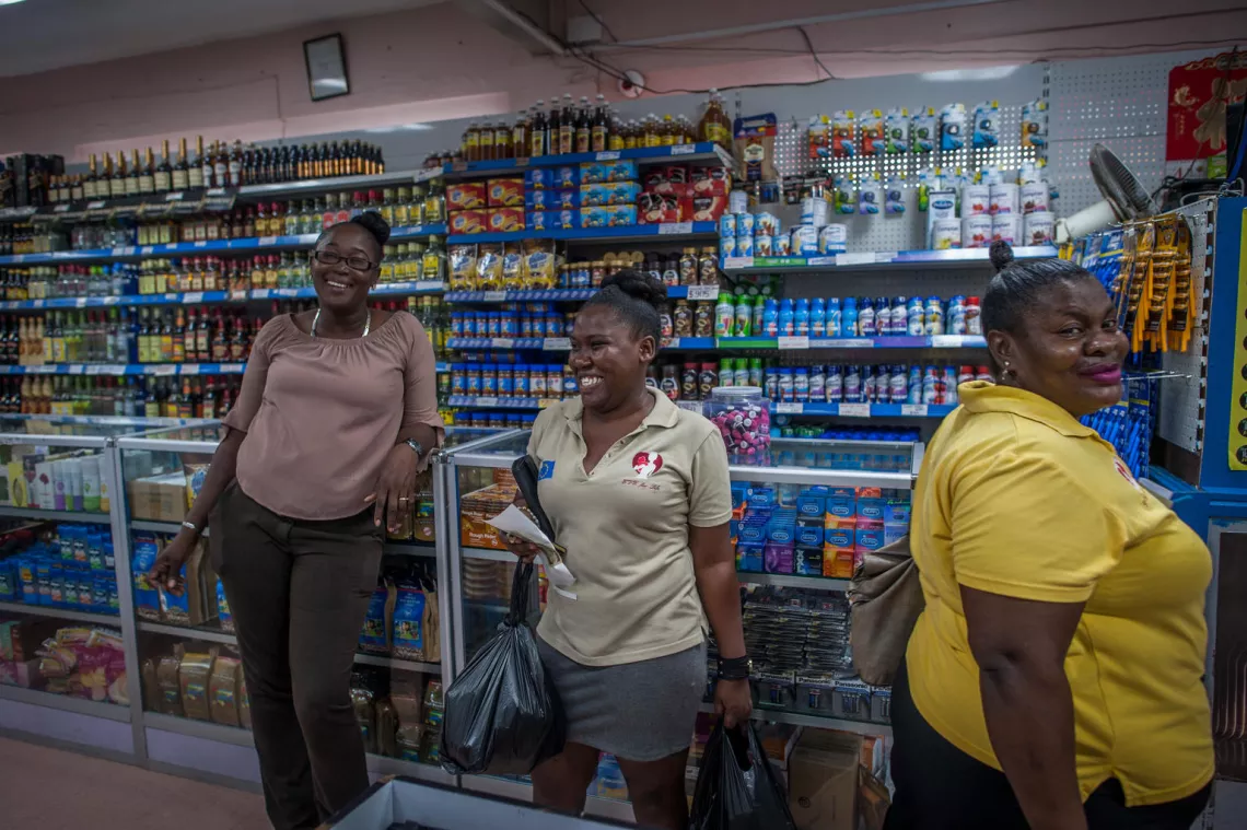 Monique McDonald, 27, (wearing beige shirt) shops with Jerieta Kerr-Green (yellow shirt) at the supermarket for essential supplies for a woman in need who is part of the EVE for Life's program