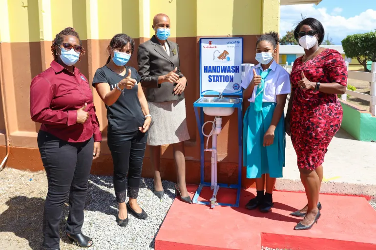 Partners in the ongoing Resilient Schools Programme, Kivette Silvera (left), Executive Director, Food For the Poor; Mariko Kagoshima (second left), UNICEF Country Representative; and and Yanique Forbes-Patrick (right), Vice-President, Communications and Corporate Affairs, Scotiabank, are photographed with Fayval Williams, Minister of Education, Youth and Information  (third left) and Grade 6 student Teona Dietrich during the handover of handwashing stations to Port Henderson Primary School in Portmore, St C