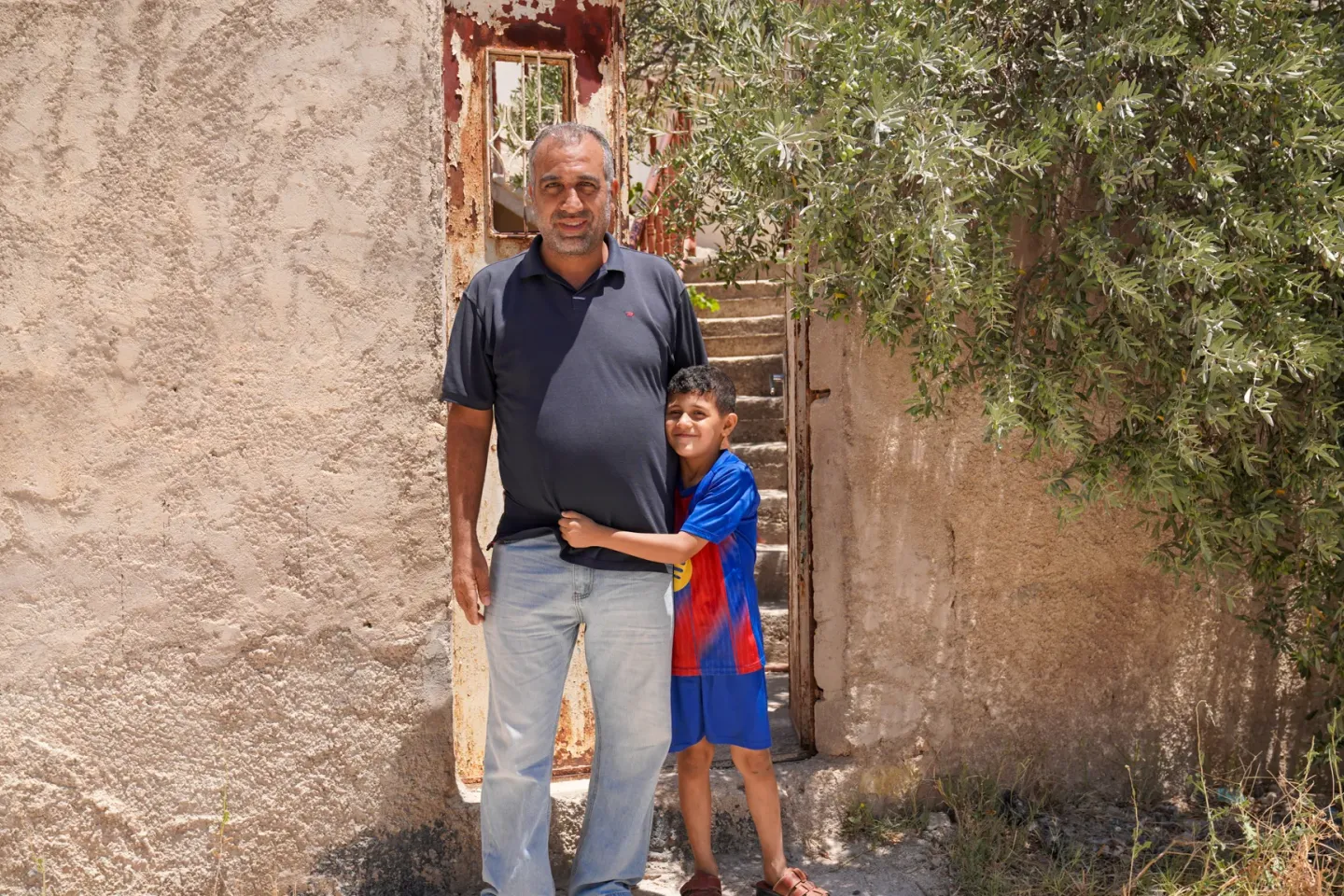 A man and a child standing.