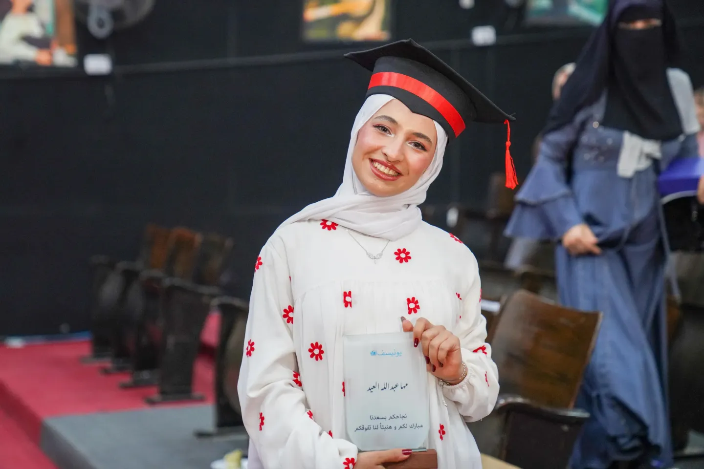 A girl dressed in a graduation gown.