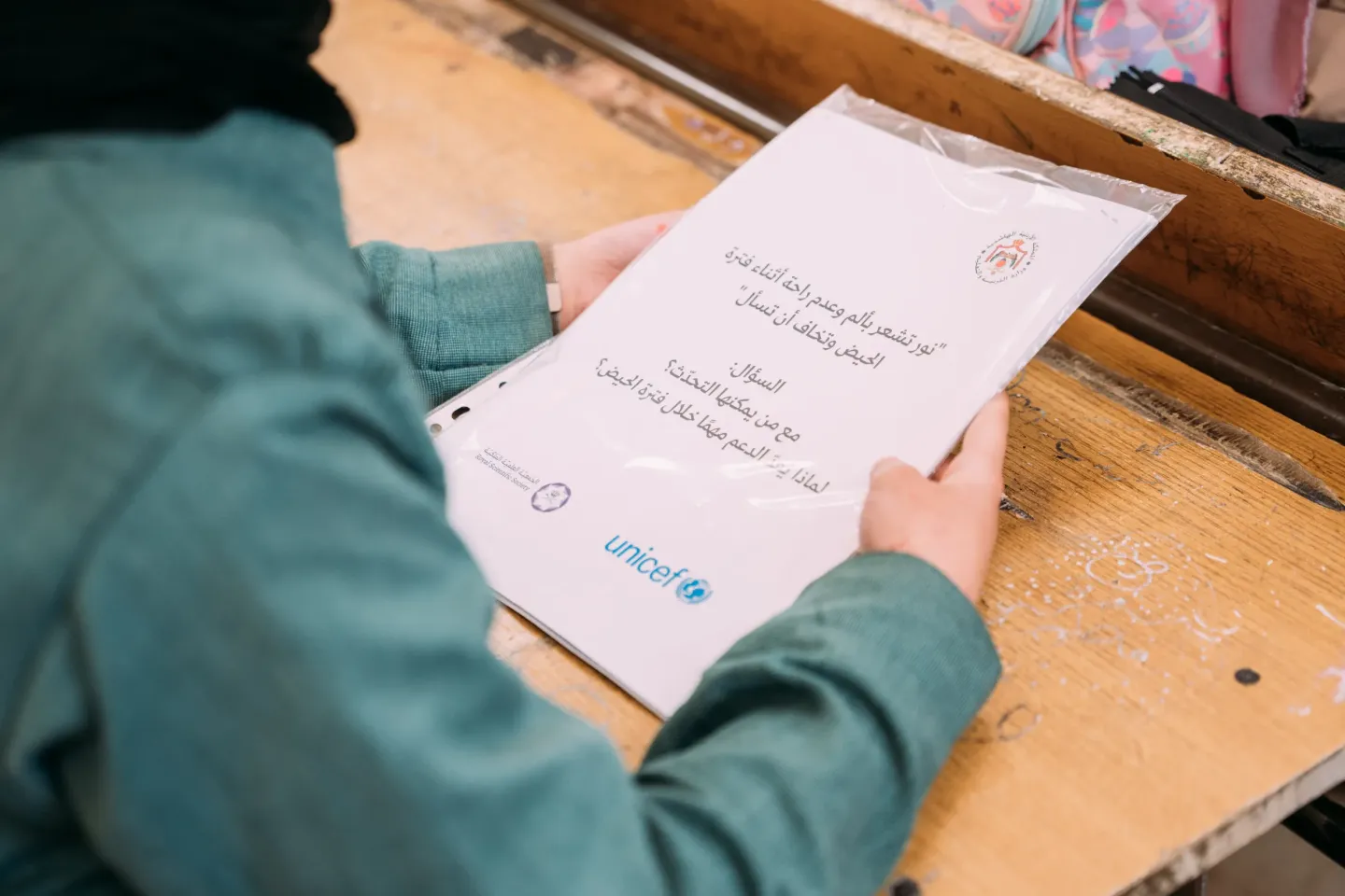 A student reads a menstrual health awareness booklet at a school in Za&rsquo;atari Camp. 
