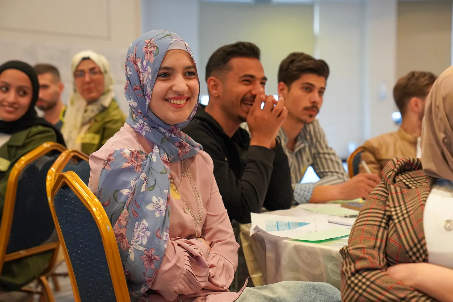 Young people sitting around a table.