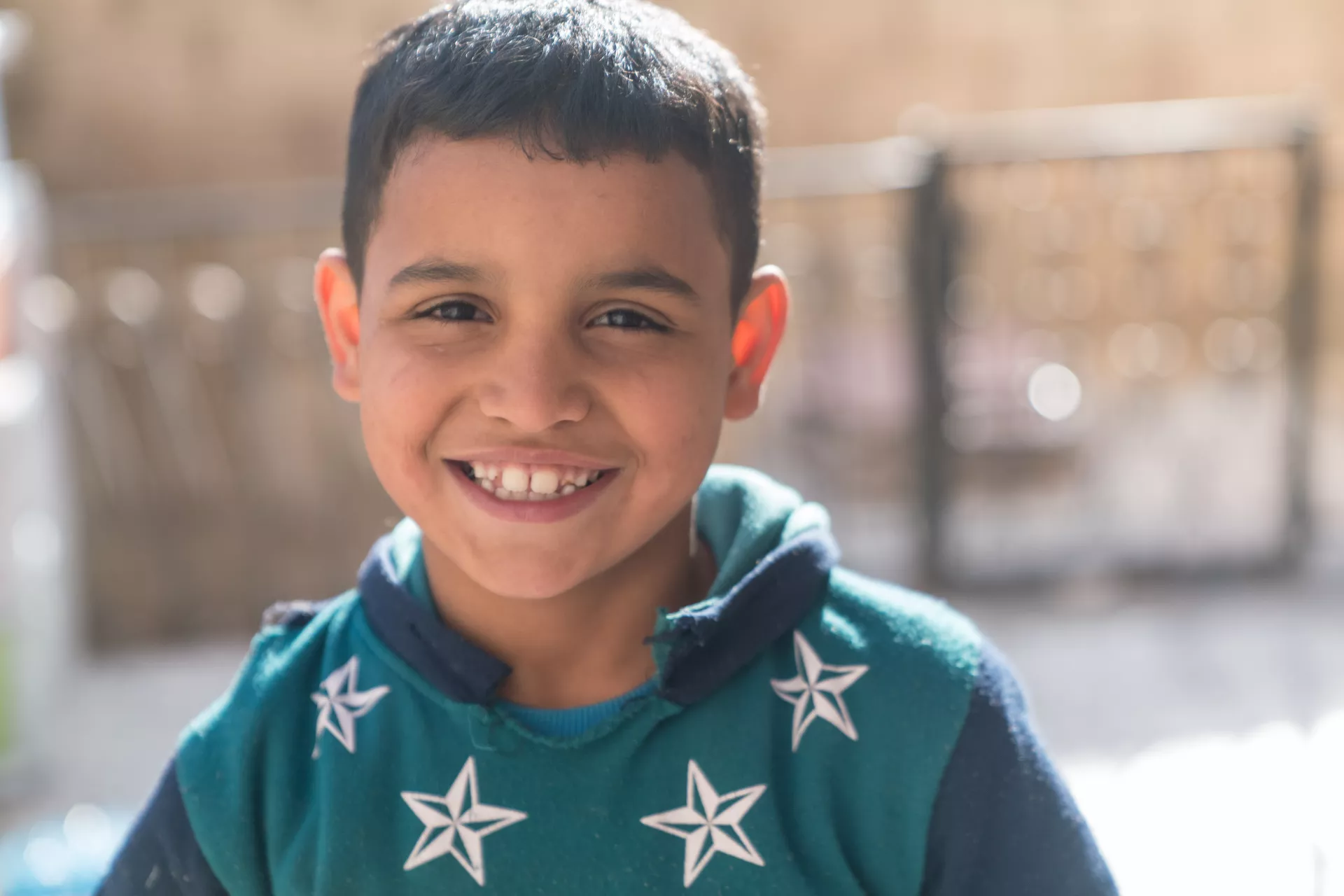 A boy outside his home