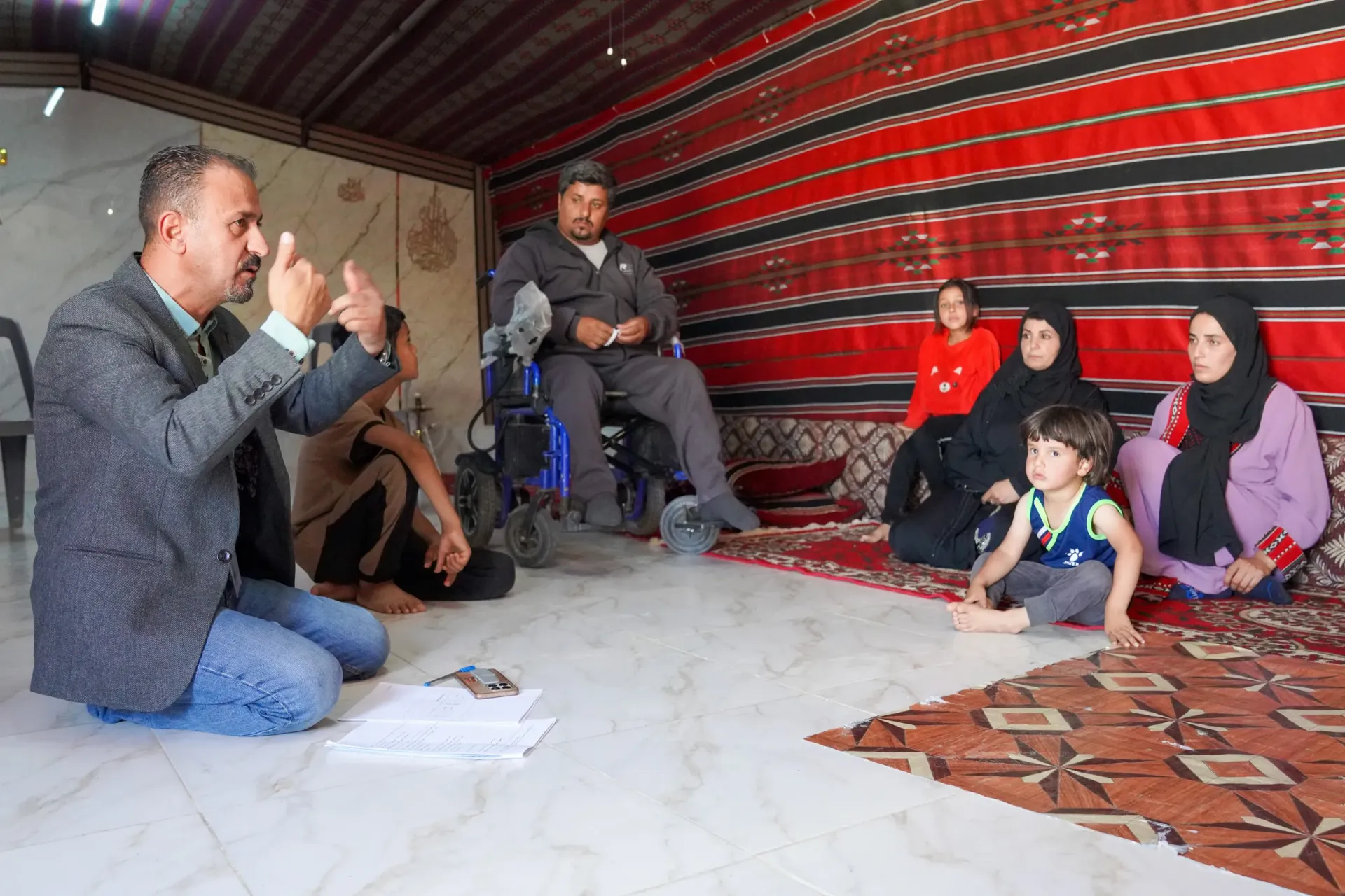 A man talking to a group of people.