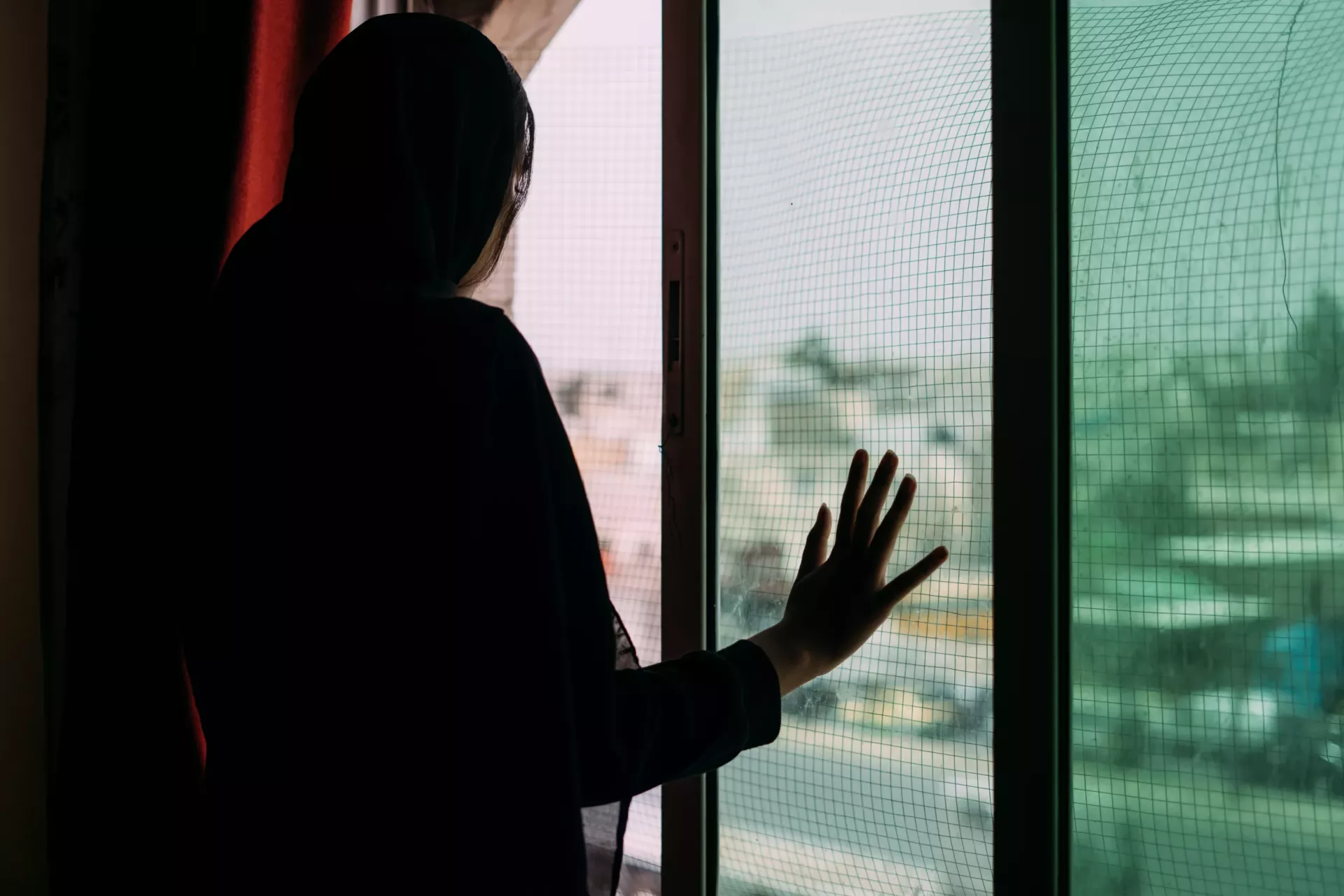 A girl looking through a window. 