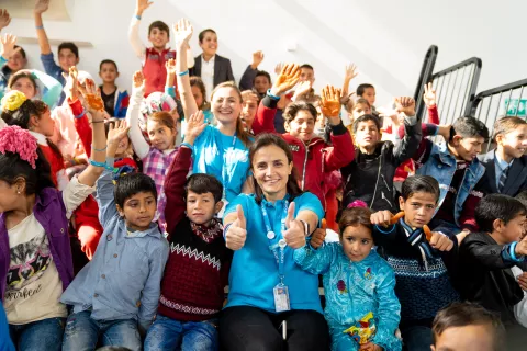 UNICEF staff pose with children 