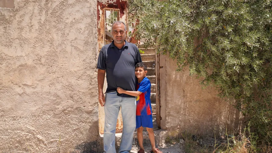A man and a child standing.
