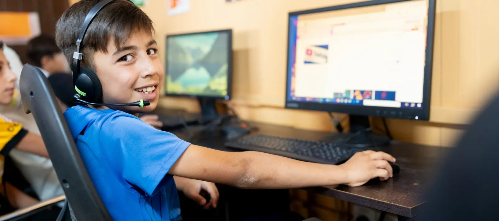 A boy using a computer.