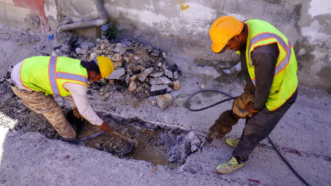 Workers fixing pipes.