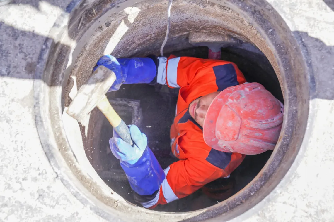 A sanitation worker inspects the sewage network. 