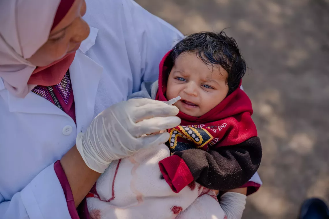 A health worker vaccinating a  child.