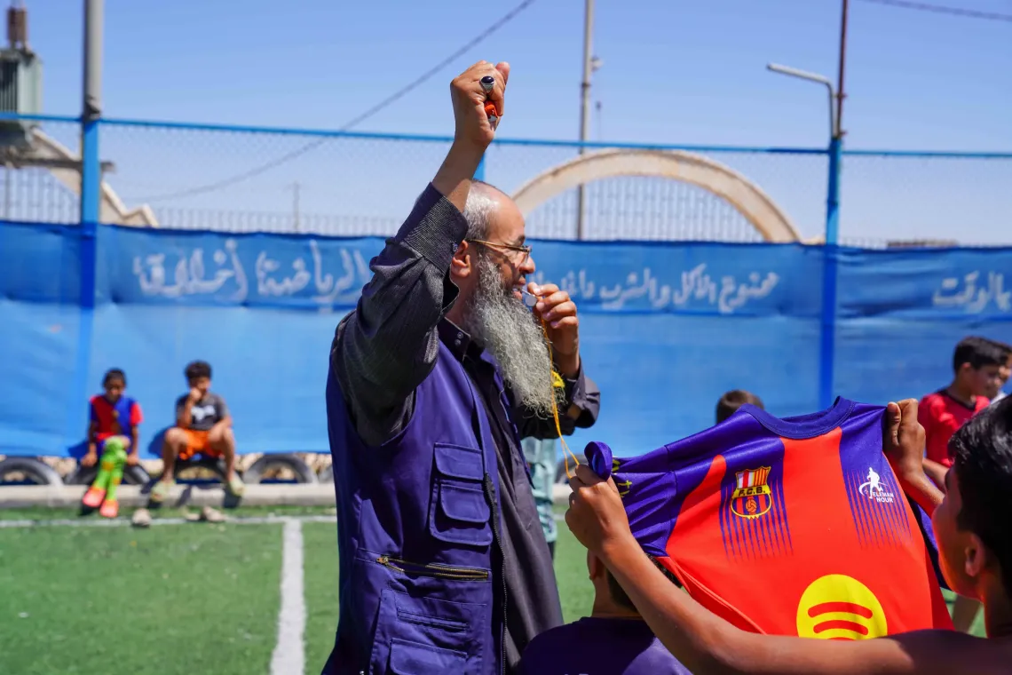 Abu Sam celebrates with the children after the game