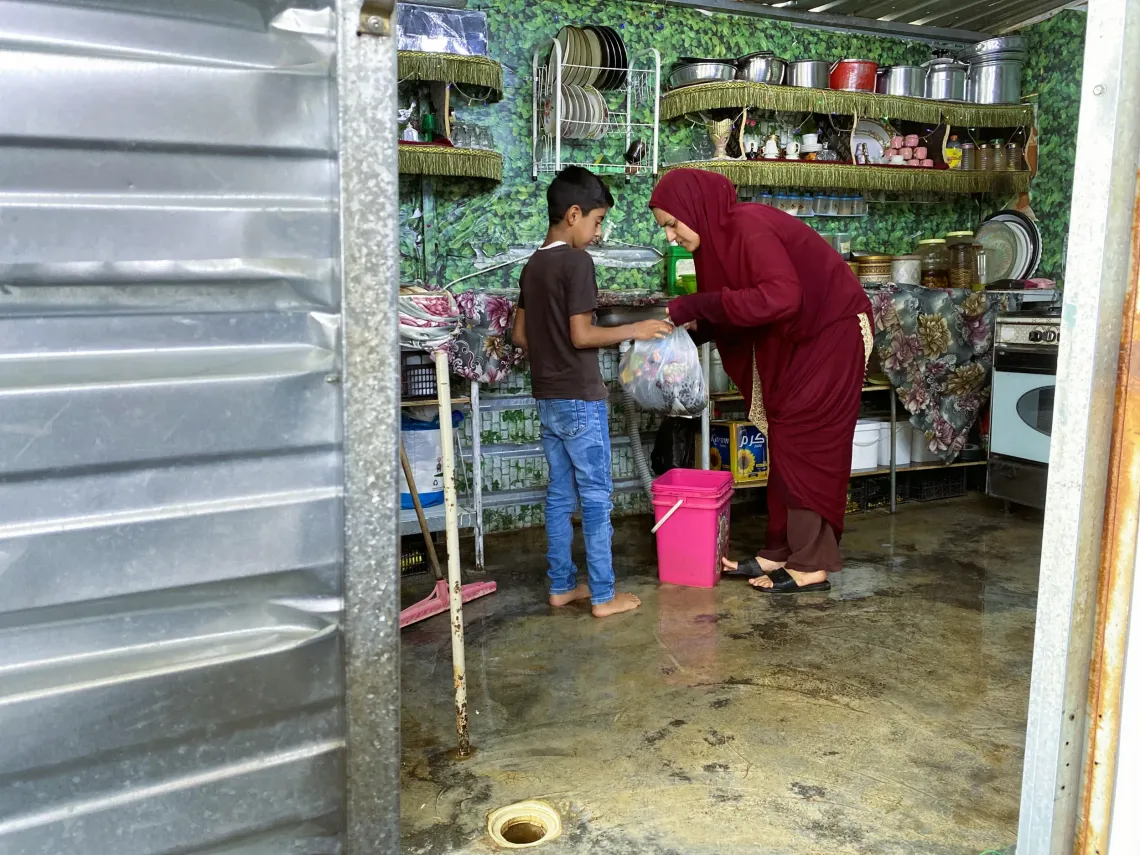 A boy lending a hand to his mother.