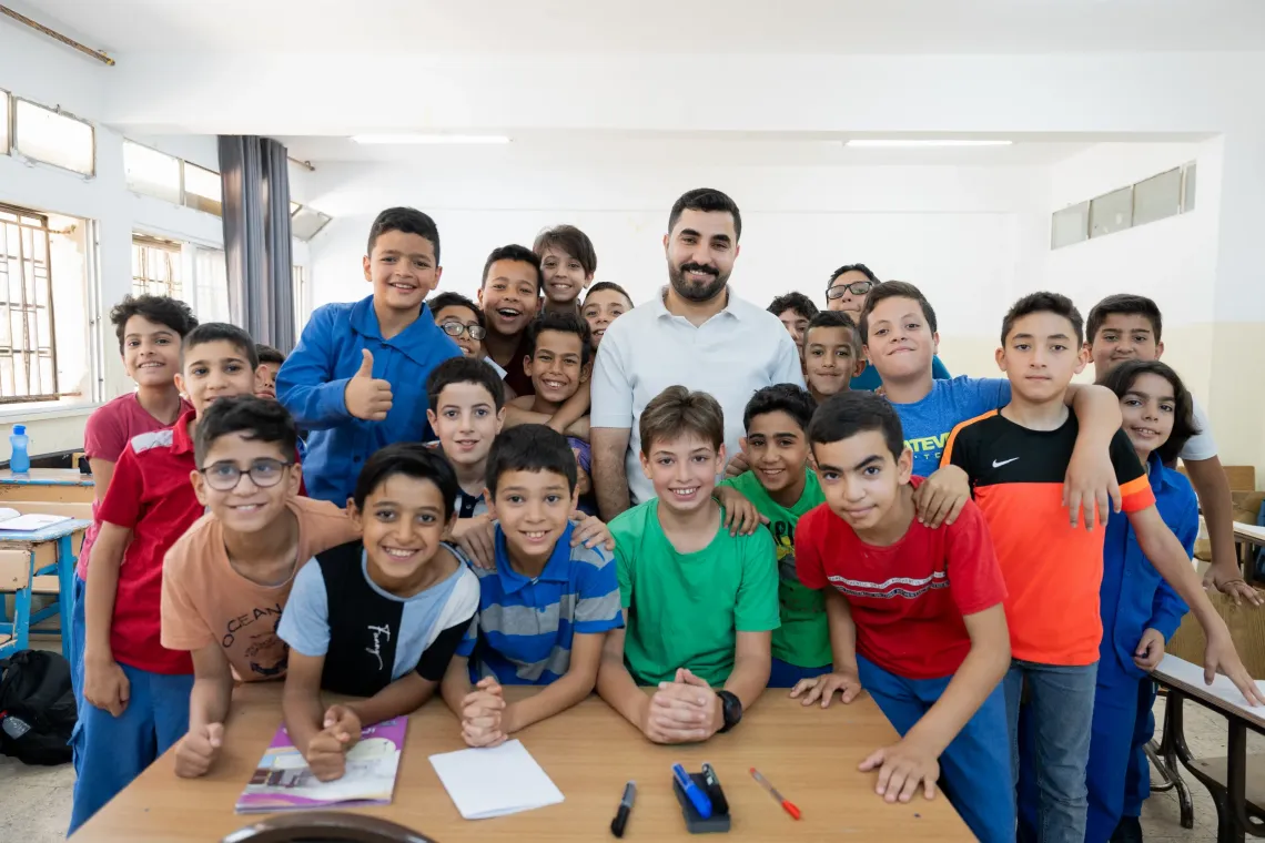 A group photo for a teacher and students in the classroom 