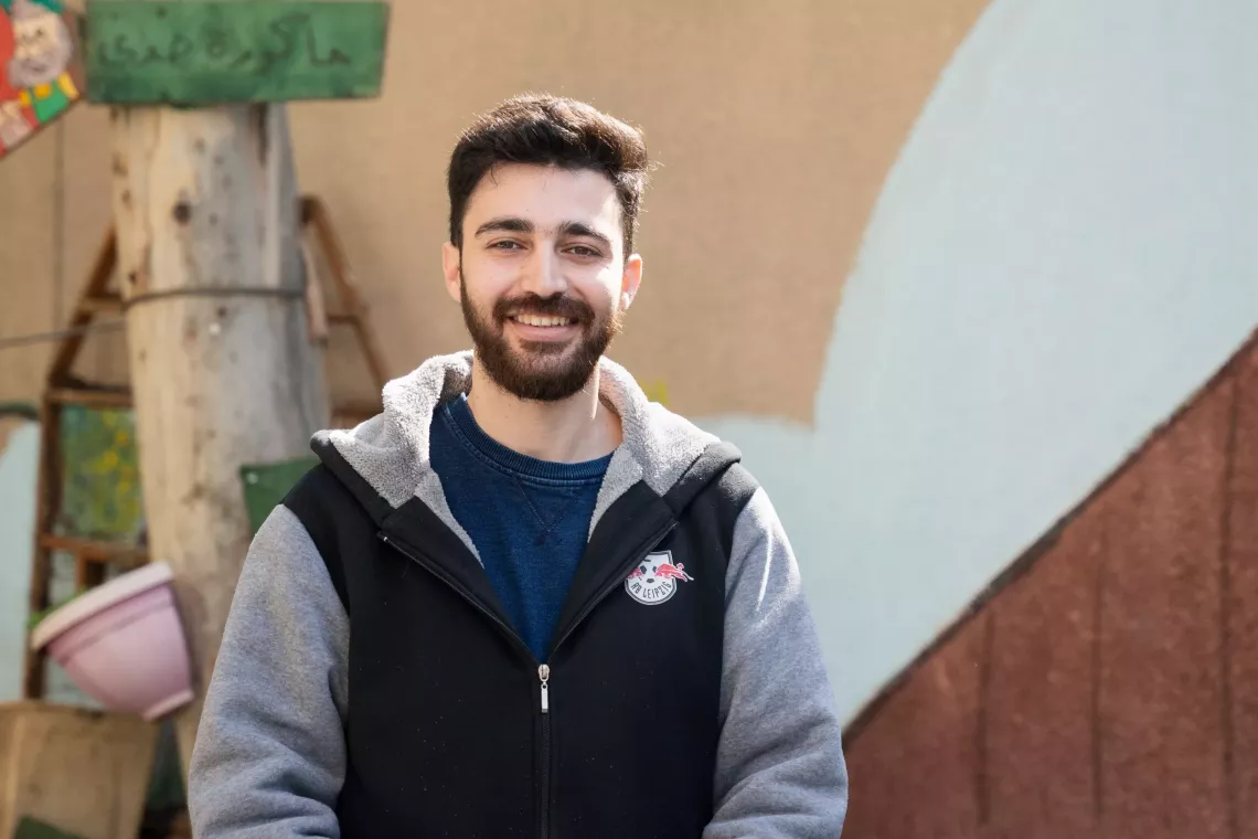 a young man smiling at the camera.