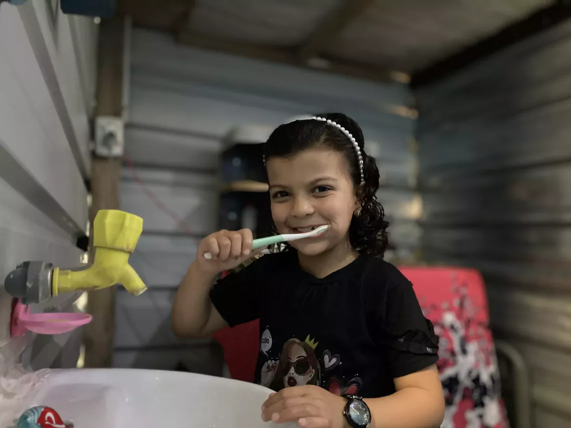 A girl brushing her teeth.