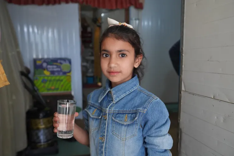 A girl drinks water. 