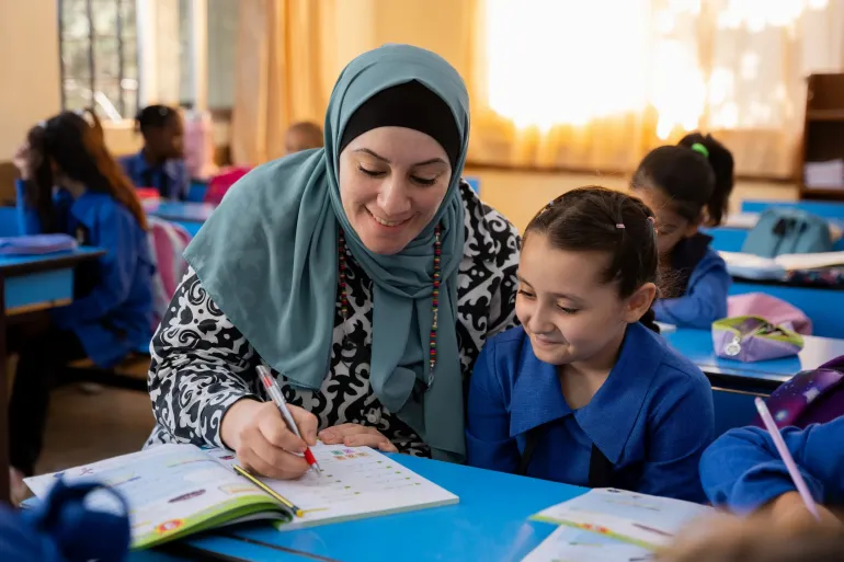 A teacher supports students through collaborative, hands-on learning in the classroom