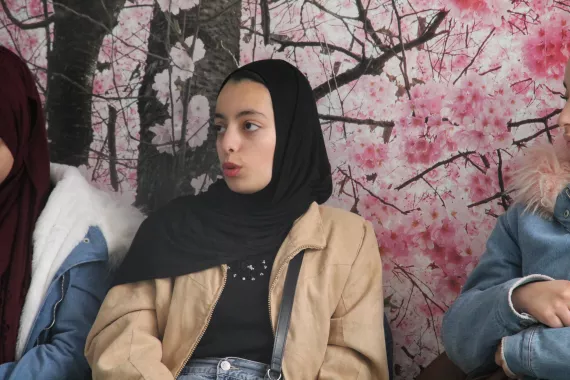 a girl against a pink wall