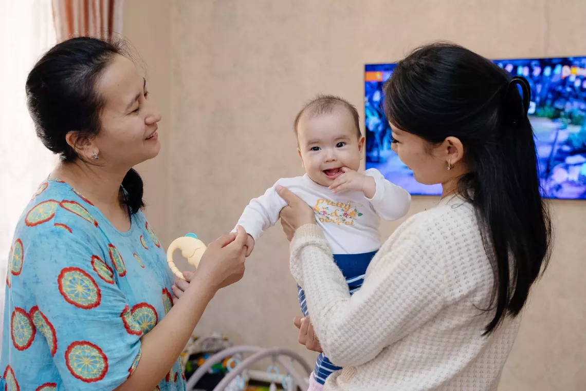 a mother with her baby and a visiting nurse