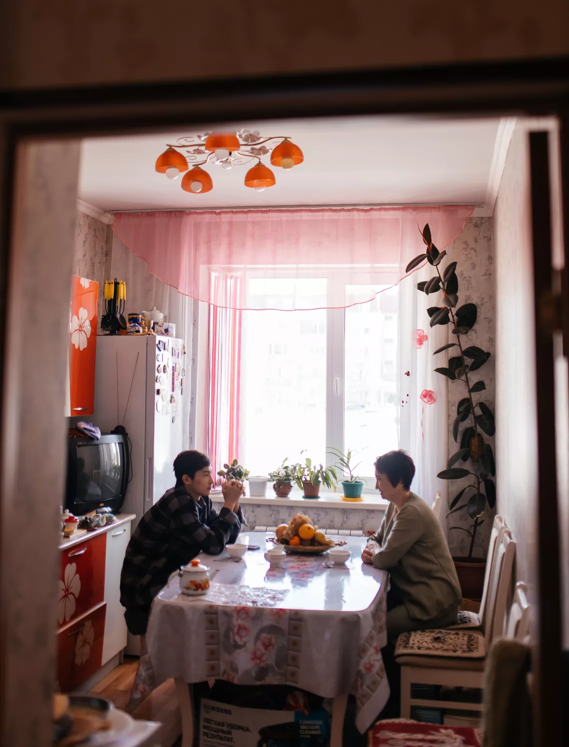 Aizhan Yerulanova and her son, Yerasyl (16), in their kitchen. Ust-Kamenogorsk, Kazakhstan.