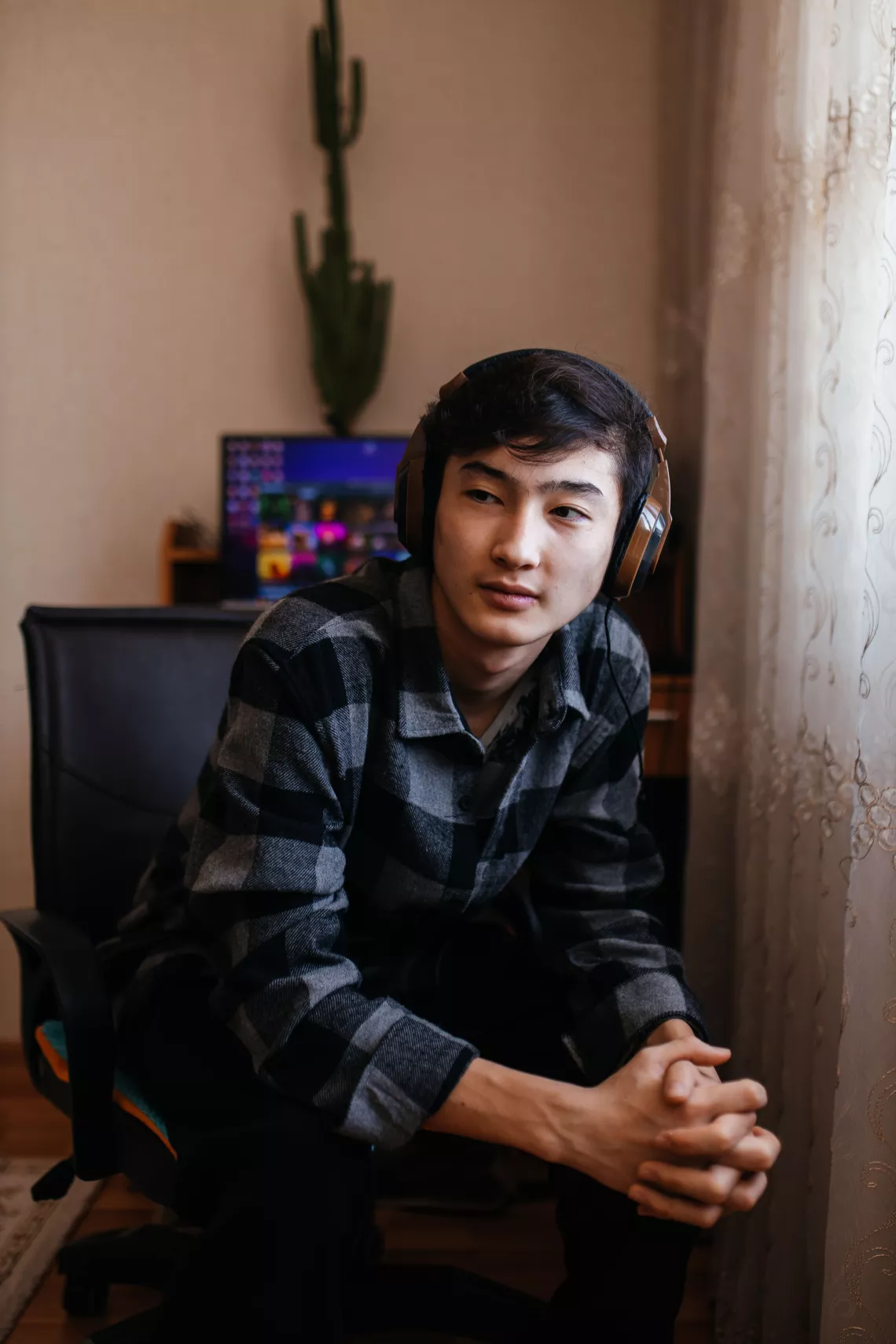 Yerasyl Yerulanov (16) at a computer in his room. Ust-Kamenogorsk, Kazakhstan.