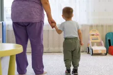 a boy holding hands with a woman