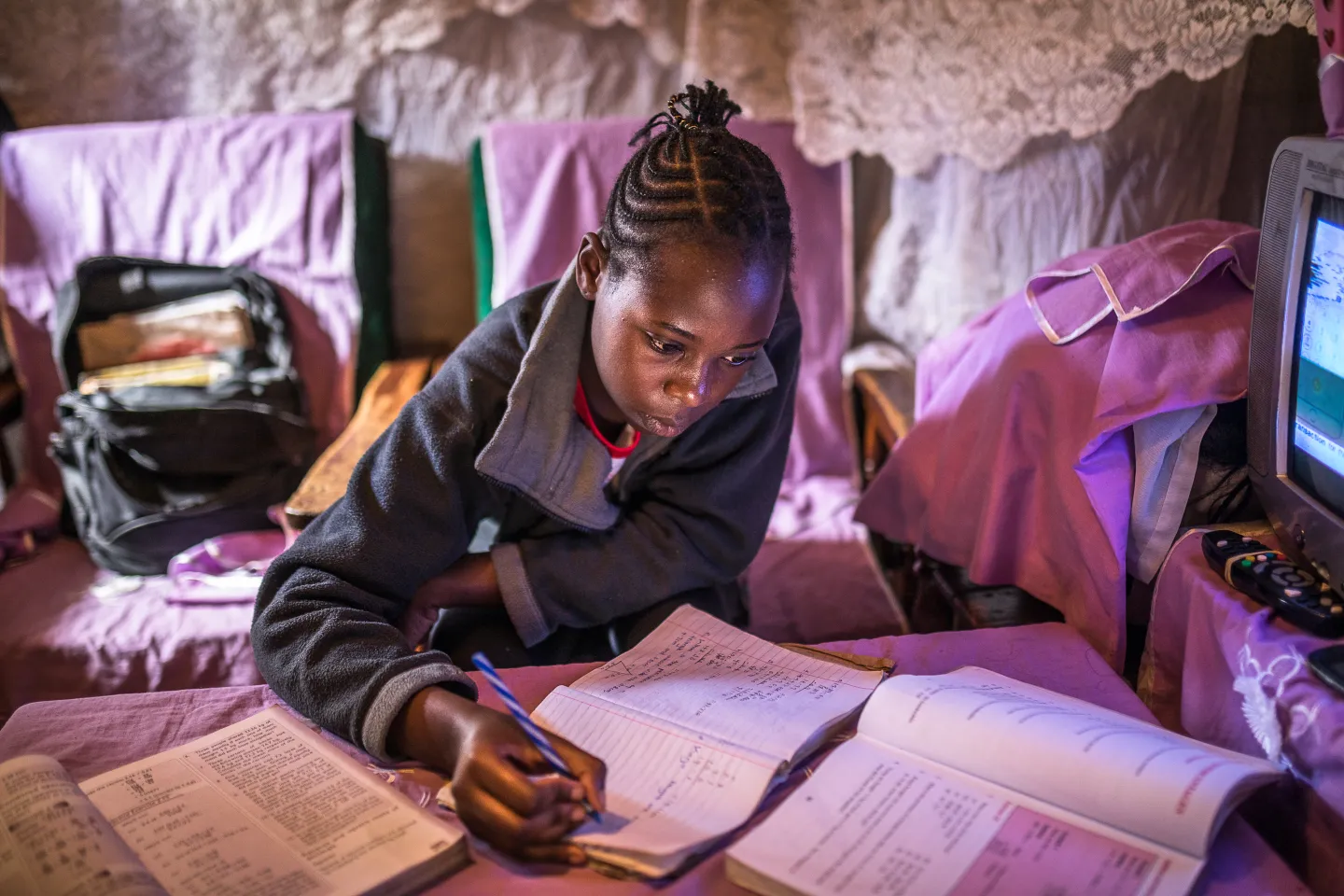 Shiela studies at home in Kibera