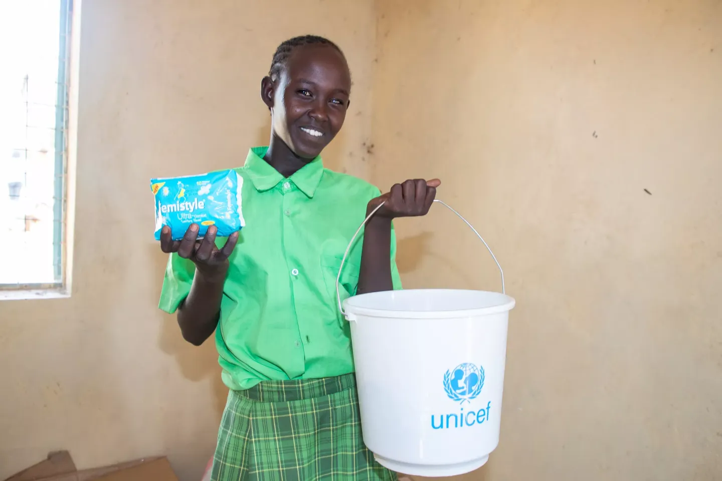 Nancy Leitana shows some of the menstrual hygiene products she received from her school 